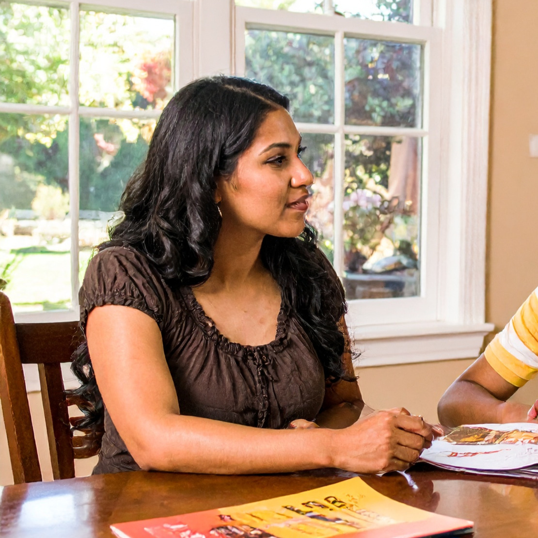 Icon image of a mother at a table advising a son who is off-camera